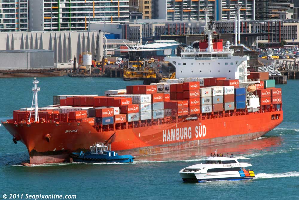 BAHIA (2007/41483gt/IMO 9360732) - Hapag-Lloyd's Liberian-flagged containership, sails from Auckland, NZ as the local commuter/tourist ferry ADVENTURER passes by giving her passengers a close-up view of proceedings. 10 September 2011. Photo by SeapixOnline.com