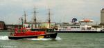 ID 8517 A pilot launch seen outbound into The Solent from Gosport, England. In the background are the iron-clad warship HMS. WARRIOR (1860) and the Portsmouth-Isle of Wight ferry ST. CATHERINE (renamed GB...