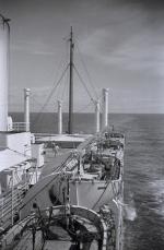 ID 8197 Lazy days in the Pacific approaching Panama on the RANGITANE, homeward bound from Wellington, New Zealand. There is a game of deck tennis in progress. Many will be having an afternoon rest away from...