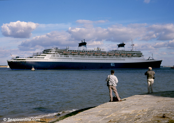 NORWAY (1961/76049grt/IMO 5119143, ex-FRANCE. Renamed BLUE LADY prior to scrapping) is towed past Calshot into The Solent for compass adjustments after her 1996 refit at the A&P shipyard in Southampton, England.
 1996. Photo by SeapixOnline.com/Trevor Coppock