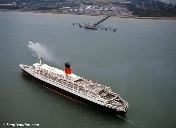QUEEN ELIZABETH 2 (1969/70327grt/IMO 6725418) passing the BP oil facility at Hamble, inbound to Southampton, England from a German shipyard where repairs were made to damage sustained when she ran aground in Martha's Vineyard, USA. 1992. Photo by SeapixOnline.com/Trevor Coppock