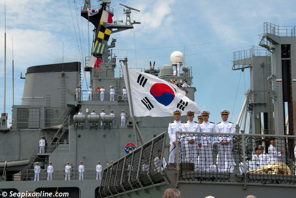ROKS CHUNGMUGONG YI SUN-SHIN (DDH 975) and ROKS DAECHEONG (AOE 58) visit Auckland, New Zealand for a three-day goodwill call to mark 50 years of diplomatic relations between the two countries. Officers of ROKS CHUNGMUGONG YI SUN-SHIN pose for photographs as the refuelling ship ROKS DAECHEONG berths alongside in the background. 21 November 2012. Photo by Â© SeapixOnline.com