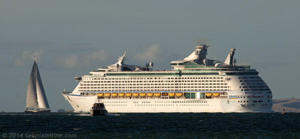 VOYAGER OF THE SEAS (1999/137276grt/IMO 9161716) in the Rangitoto Channel, passes an inbound superyacht while outbound from Auckland, New Zealand to the port of Tauranga in the Bay of Plenty. 13 March 2014. Photo by  © 2014 SeapixOnline.com