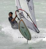ID 3540 WINDSURFER - enjoys a stiff breeze on Auckland's Waitemata Harbour, New Zealand.