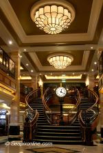 ID 6808 QUEEN ELIZABETH (2010/90901gt/IMO 9477498) - staircase leading from the Empire Casino on Deck 2 up the Royal Arcade shopping area on Deck 3 where your casino winning can be well spent.