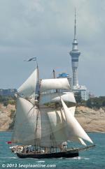 ID 9314 R. TUCKER THOMPSON with all sails set passes along the East Coast Bays of Auckland with the Skytower, 4-5kms distant, dominating the skyline. 