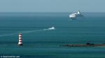 ID 8335 RANGITOTO LIGHTHOUSE - an automated beacon, stands at the entrance to the main shipping channel into Auckland, New Zealand. An incoming cruise ship approaches to be met by the Ports of Auckland pilot...