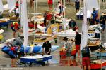ID 8897 MURRAYS BAY SAILING CLUB, NEW ZEALAND - Competitors in a sailing regatta prepare their boats on the beach outside the Murrays Bay Sailing Club on Auckland's North Shore. Many of New Zealands' yachting...
