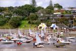 ID 8899 MURRAYS BAY SAILING CLUB, NEW ZEALAND - Competitors in a sailing regatta prepare their boats on the beach outside the Murrays Bay Sailing Club on Auckland's North Shore. Many of New Zealands' yachting...