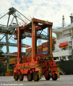 ID 8546 PORT OF SOUTHAMPTON - straddle carriers deliver 20' and 40' containers from the container stacks to the quayside for loading aboard.