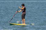 ID 12377 A paddleboarder looks to have a liking for lunch out on the water. Taken near Birkenhead Wharf, Auckland.
